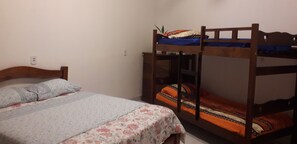 A bedroom with a single bed and a bunk bed.
