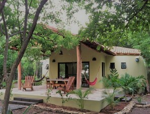 Guests can relax on the patio surrounded by lush greenery and enjoy the peaceful atmosphere.