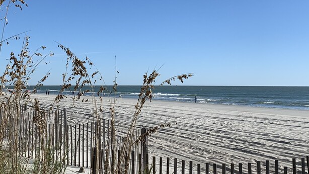 A beach with a wooden fence and waves. - SNOW BIRDS..SPECIAL RATES FOR WINTER TRAVELS - A Fun, Sun N' Surfin' Kinda Place (Murrells Inlet)