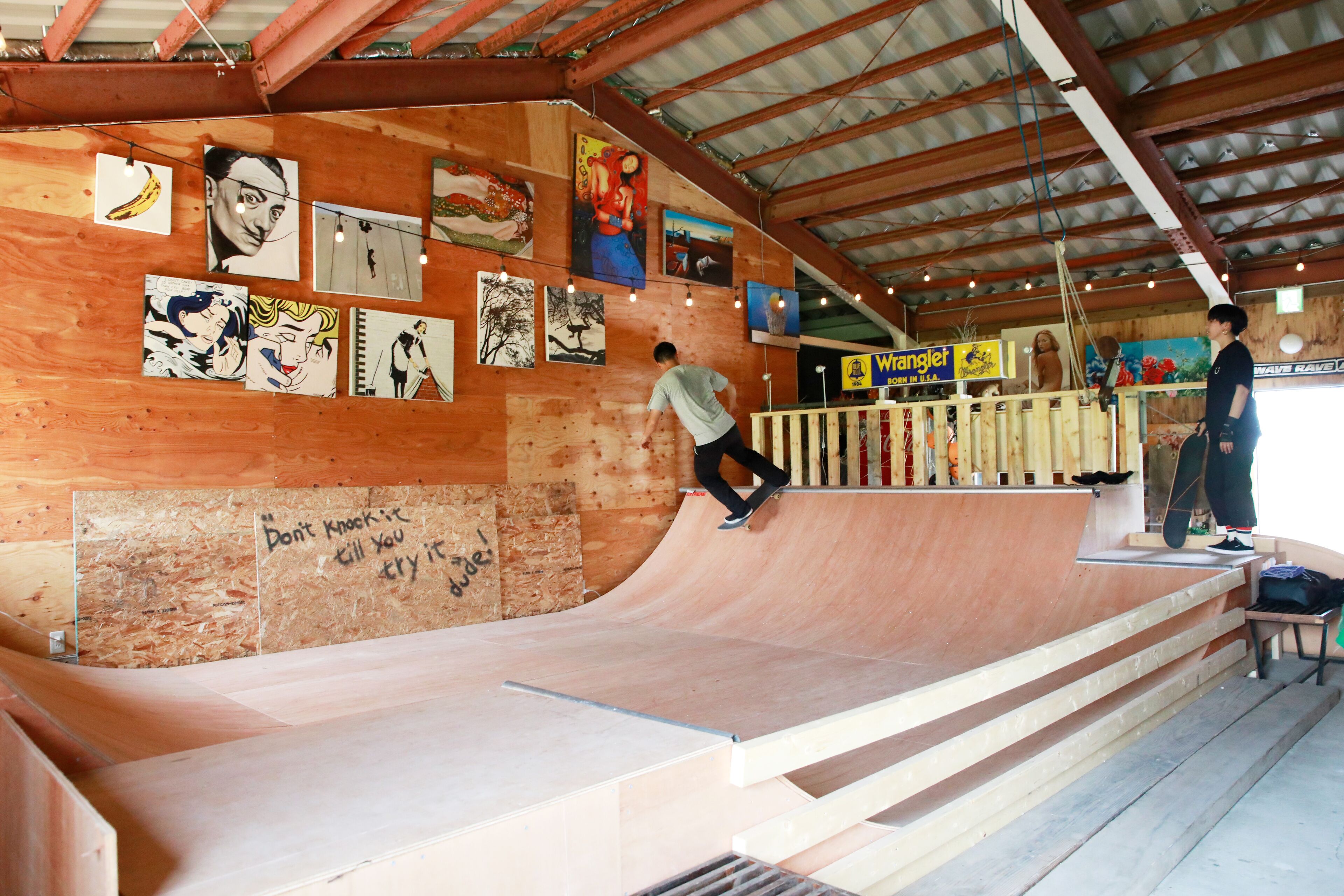 A skatepark with wooden ramps and a wooden floor.