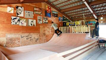 A skatepark with wooden ramps and a wooden floor.