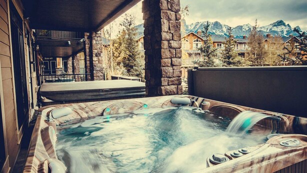 A hot tub with a view of mountains in the background.