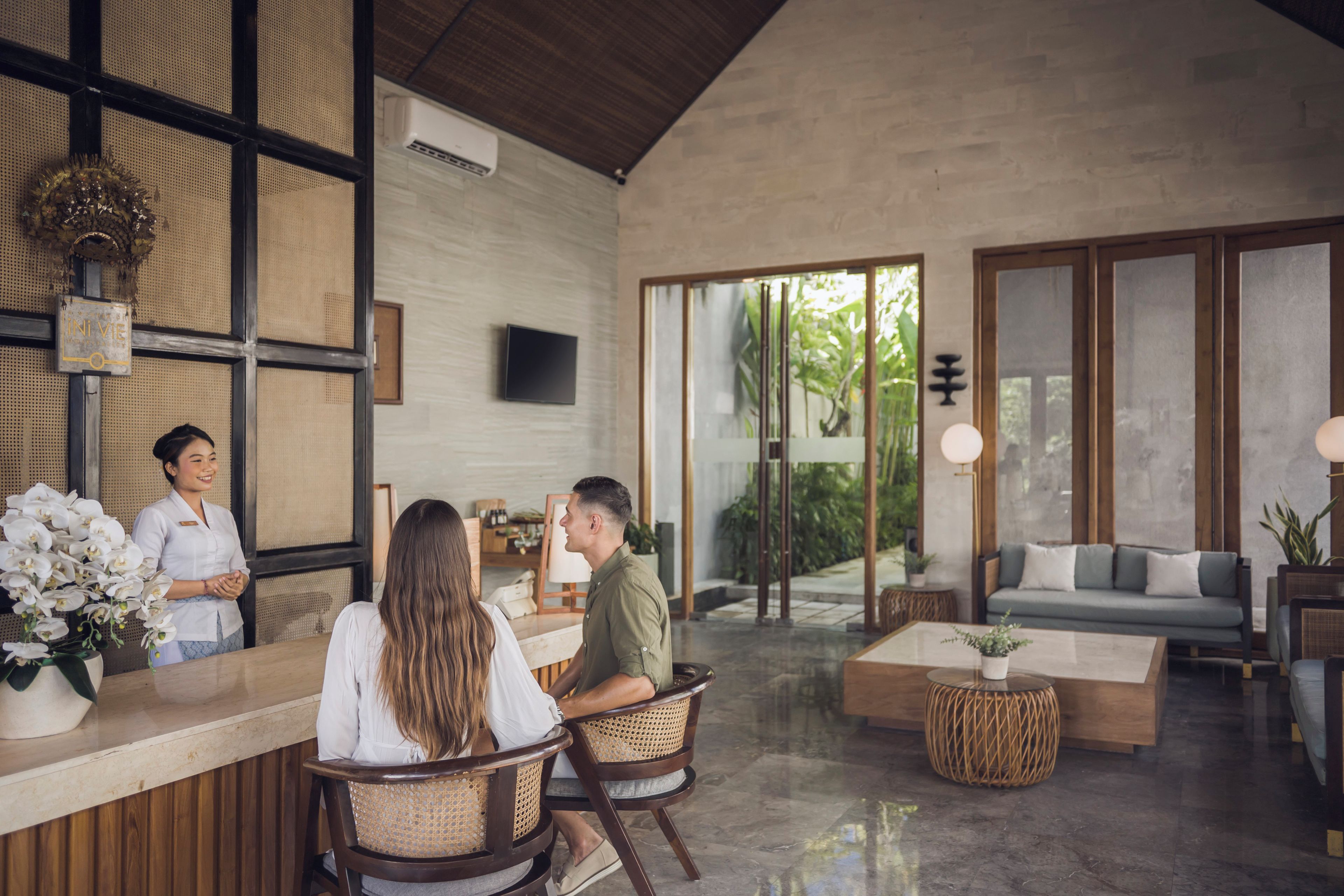 Un área de recepción con mostrador, asientos y vistas al exterior.