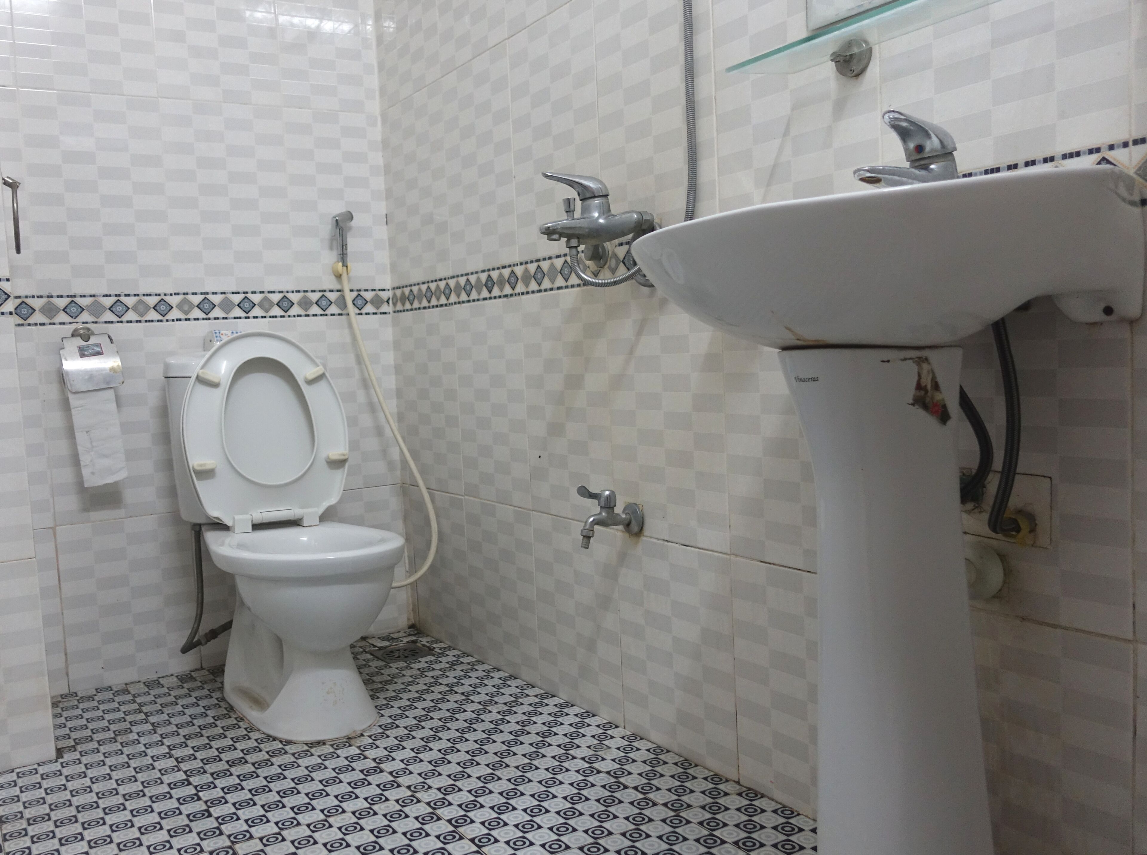 A bathroom with a toilet, a sink, and a shower.