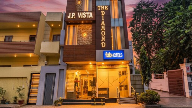 A modern hotel with a prominent 'J.P. Vista' sign, 'The Diamond' branding, and 'fabHOTELS' logo. - FabHotel Diamond (Dera Bassi)