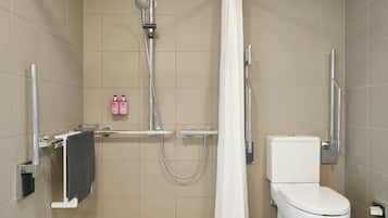 A modern bathroom with a shower, toilet, and towel rack.
