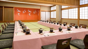 A conference room with a long table set for a meeting, wooden slats on the ceiling, and large windows. - The Gran Resort Elegante Karuizawa (Karuizawa)