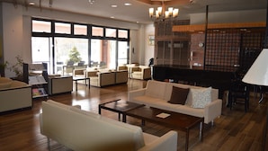 A spacious lobby with a piano, comfortable seating, and large windows. - The Gran Resort Elegante Karuizawa (Karuizawa)