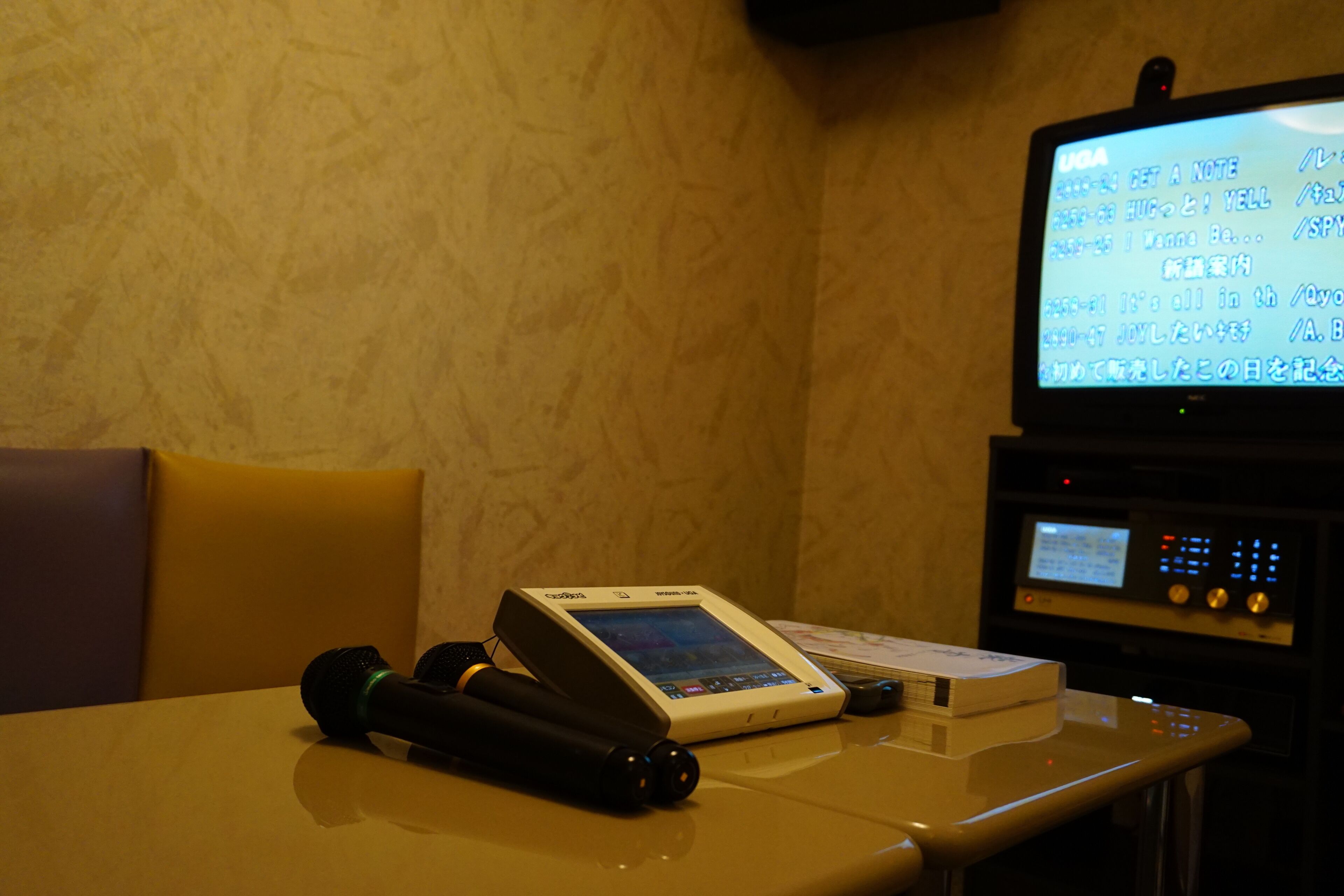 A massage chair with a control panel and a digital screen displaying text.