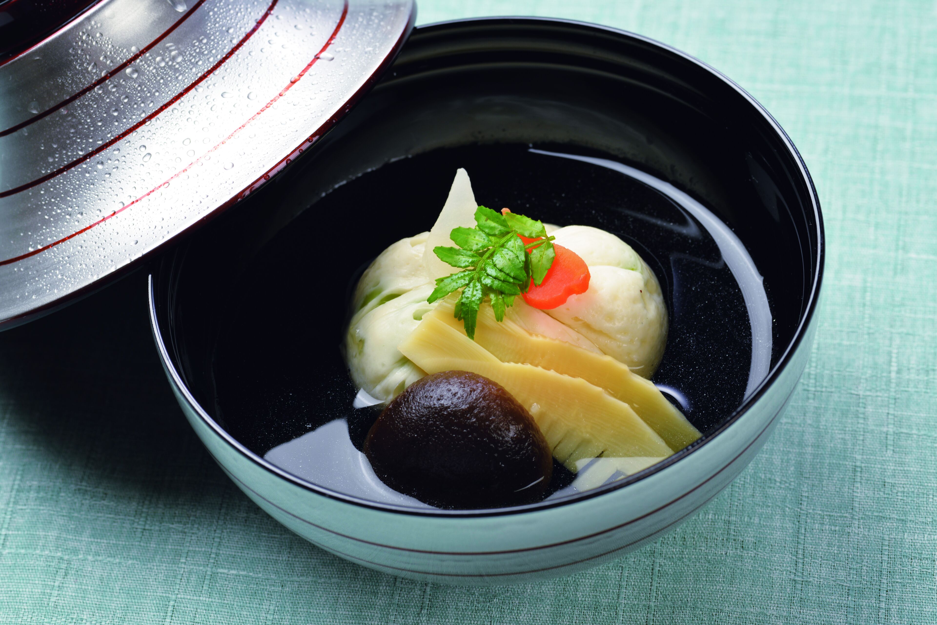 A bowl of food with a lid partially open.