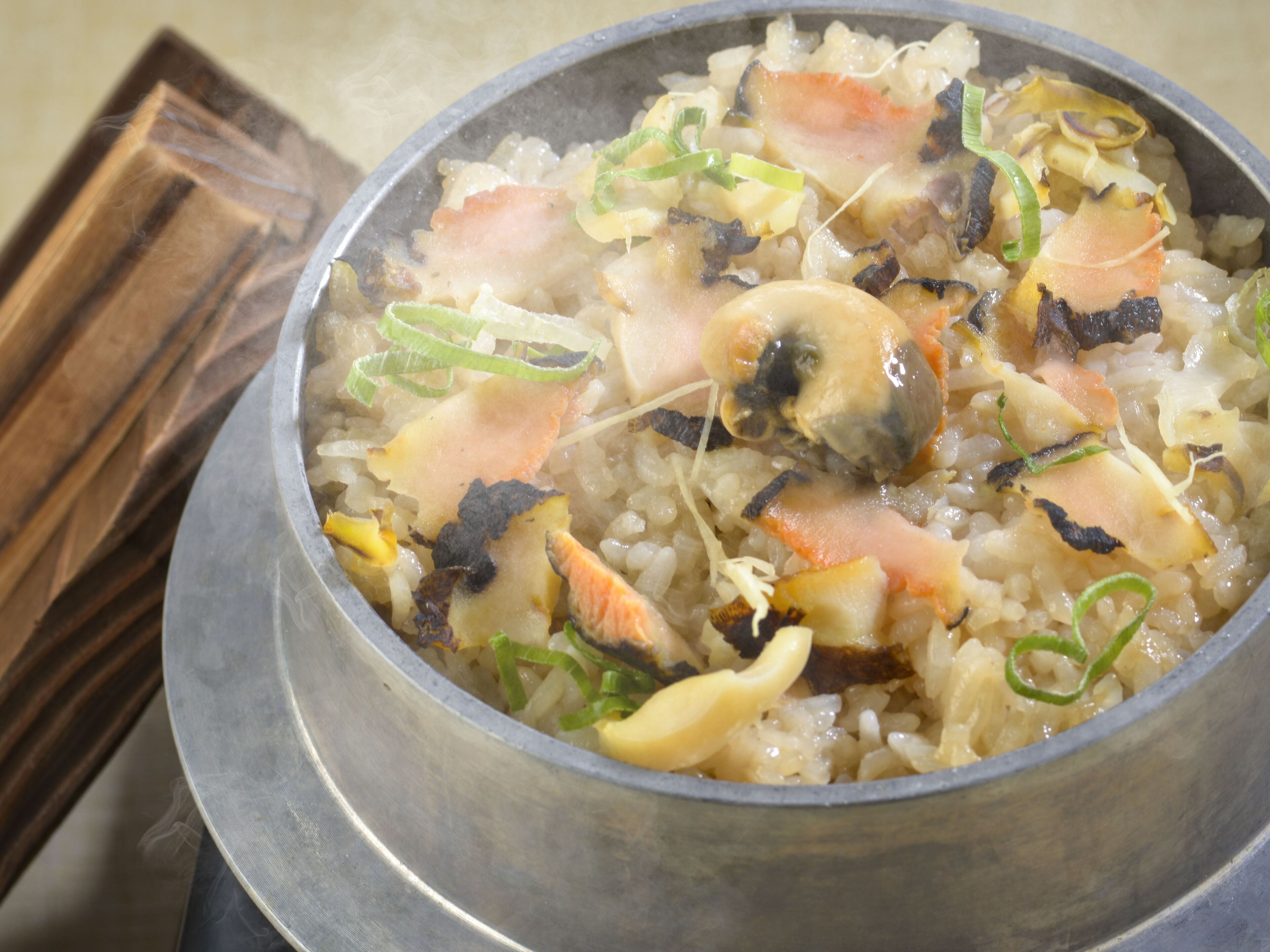 A pot of rice with seafood and vegetables.