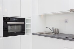 Comfort Apartment | Private kitchen | Full-size fridge, oven, stovetop, dishwasher