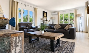 A modern living room with a sofa, coffee table, and decorative items.