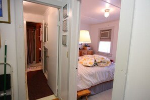 Cozy retreat with a comfortable bed, bedside table, and lamp.
