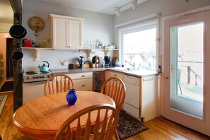 Fully equipped kitchen with stove, oven, and dishwasher, perfect for cooking and dining.