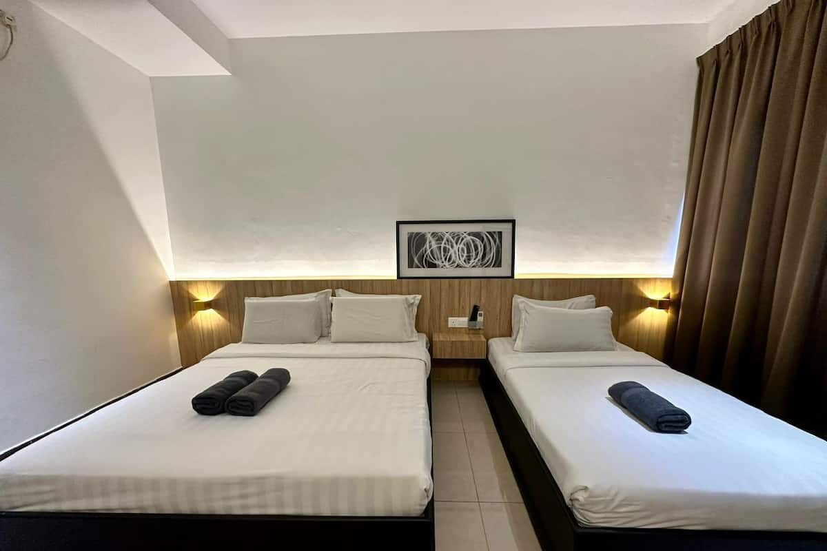 A hotel room with two beds, a nightstand, a wall-mounted artwork, and a window with curtains.