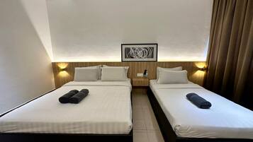 A hotel room with two beds, a nightstand, a wall-mounted artwork, and a window with curtains.