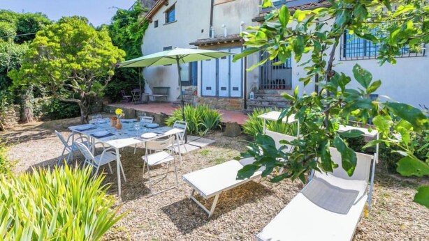 A patio with outdoor furniture, a table with chairs, and a covered area with a table and chairs. - Ridaldi by Interhome (Greve in Chianti)