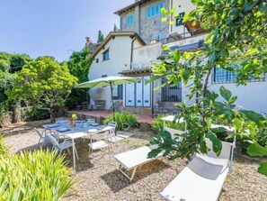 A patio with outdoor furniture, a table with chairs, and a covered area with a table and chairs. - Ridaldi by Interhome (Greve in Chianti)