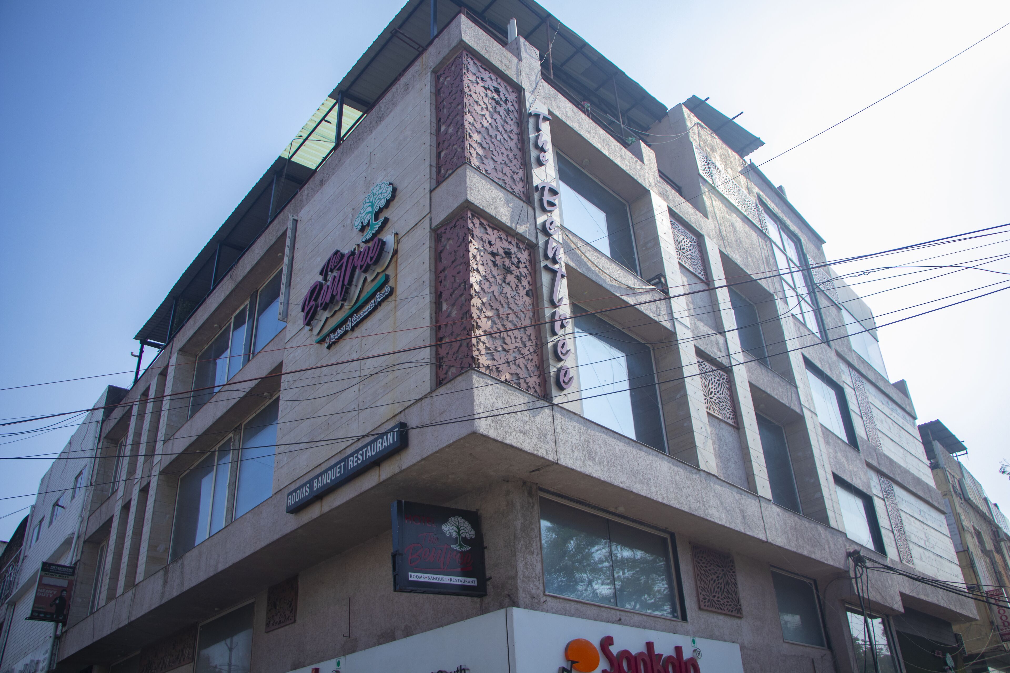 A multi-story building with various signs indicating different businesses, including a restaurant and a bank.