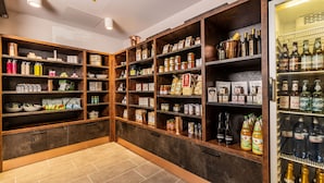 A well-organized storage room with shelves containing various food items, beverages, and kitchenware. - MASEVEN München Messe Dornach (Aschheim)