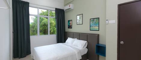 A bedroom with a bed, a window with curtains, an air conditioning unit, and a door.