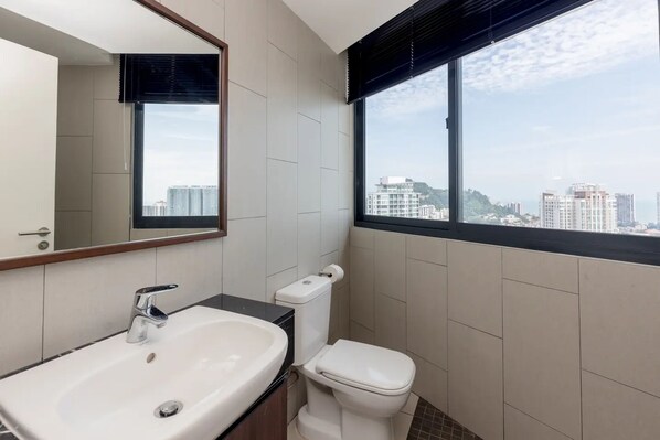 A modern bathroom with a large window, a sink, and a toilet. - Landmark by Katana by Sanguine (George Town)