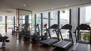 A gym with treadmills, elliptical machines, and weight equipment.