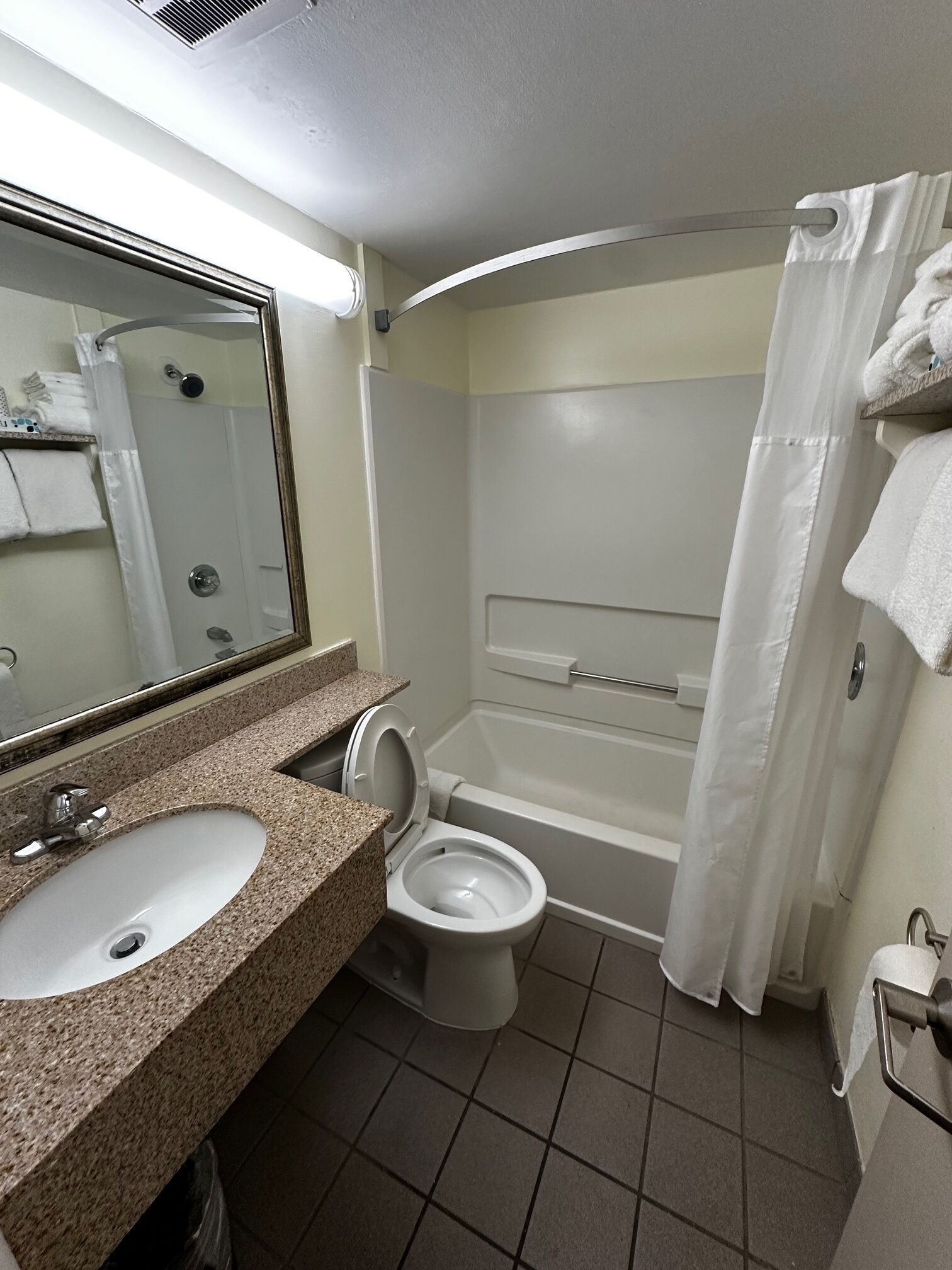 A bathroom with a sink, toilet, and bathtub.
