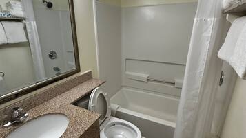 A bathroom with a sink, toilet, and bathtub.