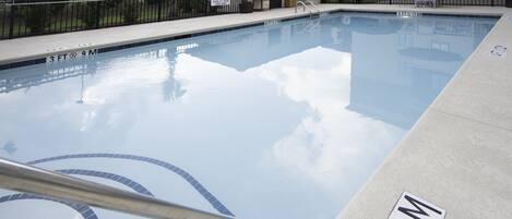 A swimming pool with a 3ft x 9m size marking, a no diving sign, and a no swimming sign.