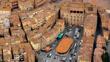 An aerial view of a densely packed urban area with narrow streets and closely built structures.