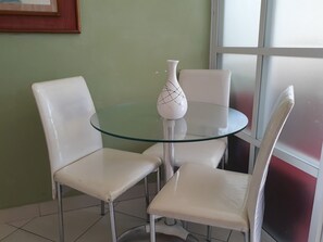 Sit comfortably in this cozy space with a round table and two chairs.