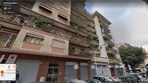 A multi-story building with balconies, some with plants. - Tiberius Suite Roma (Rome)