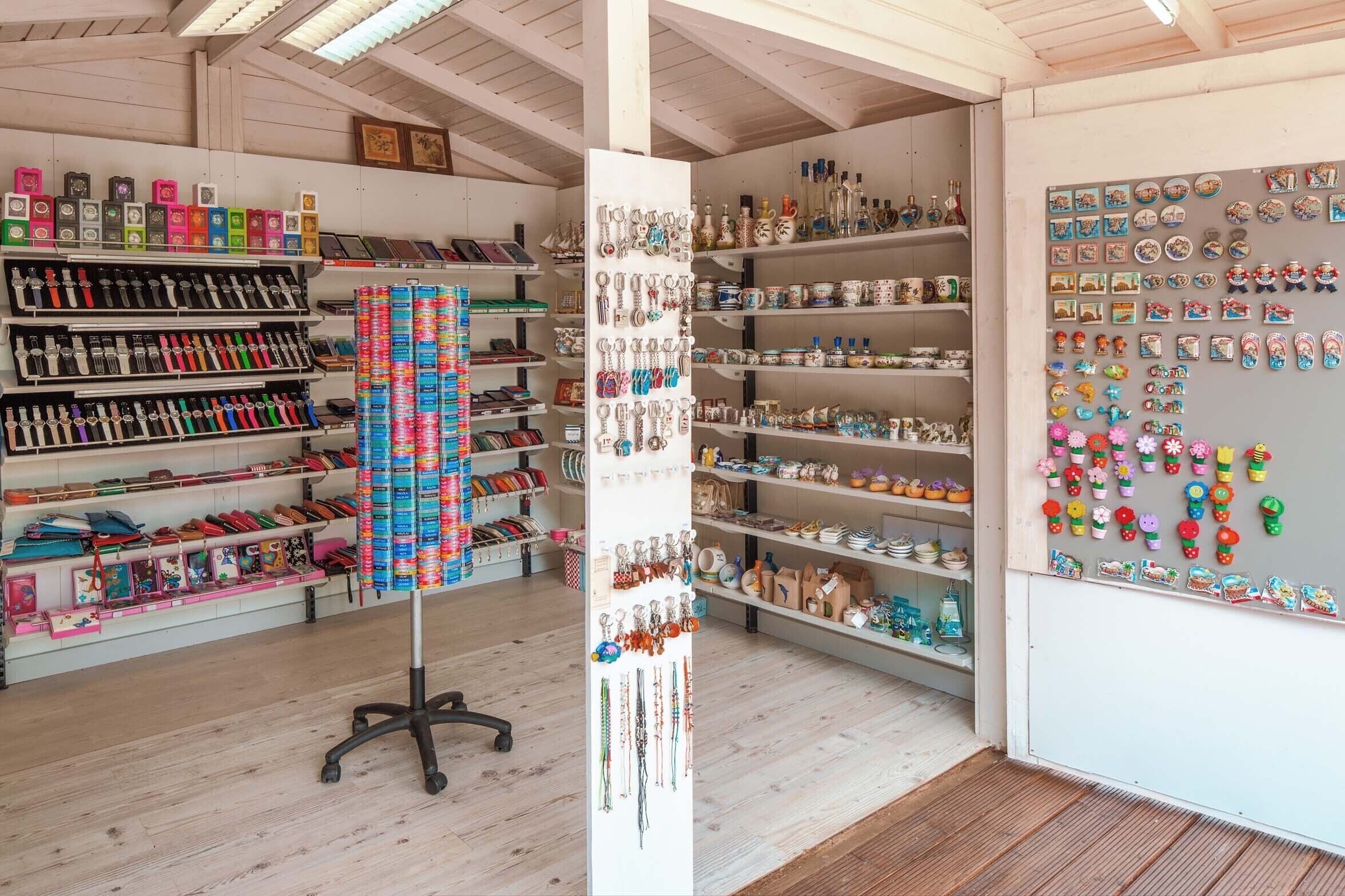 A store with shelves of various items, including bottles, boxes, and decorative objects.