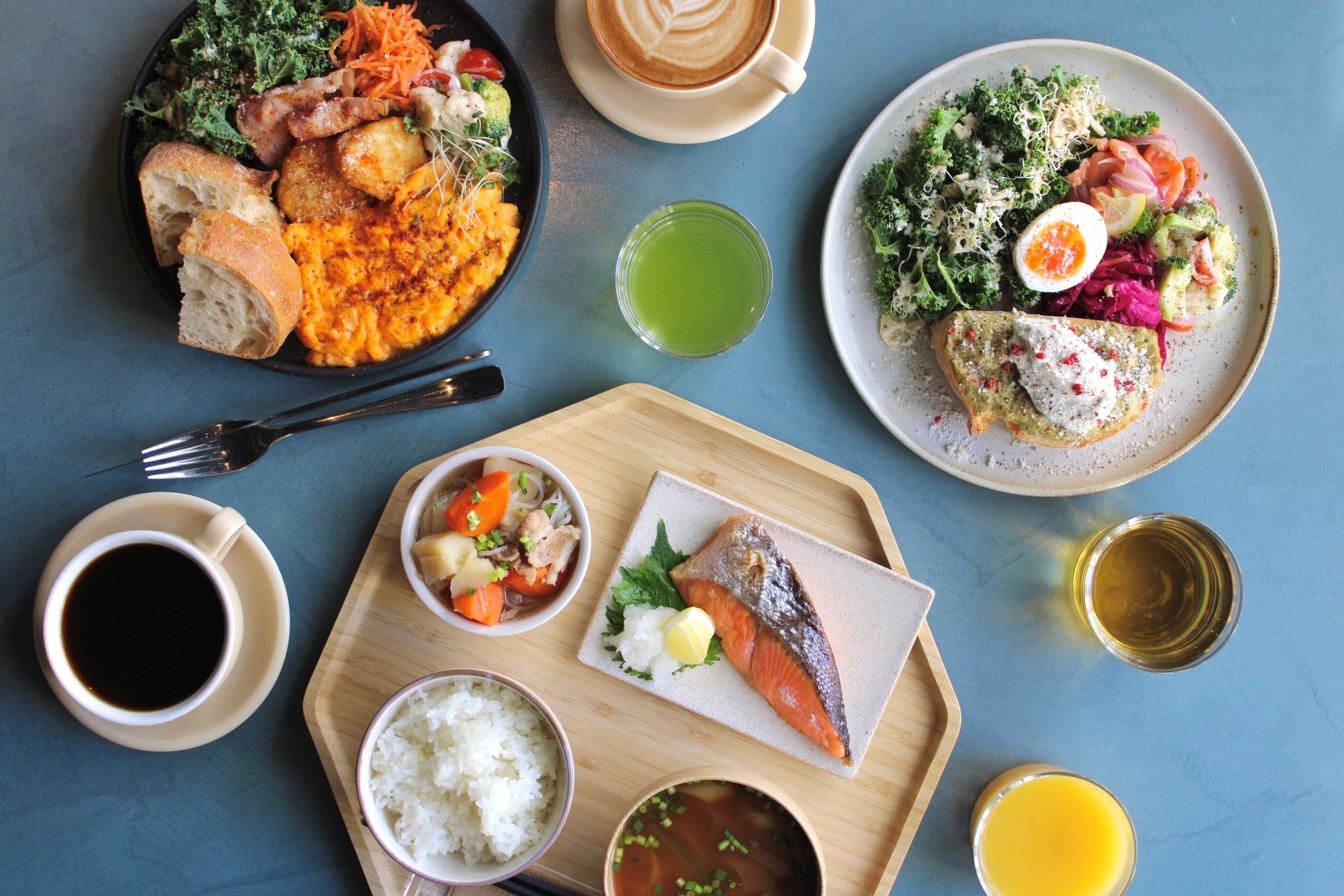 A variety of dishes including fish, rice, and vegetables, suggesting a meal setting.