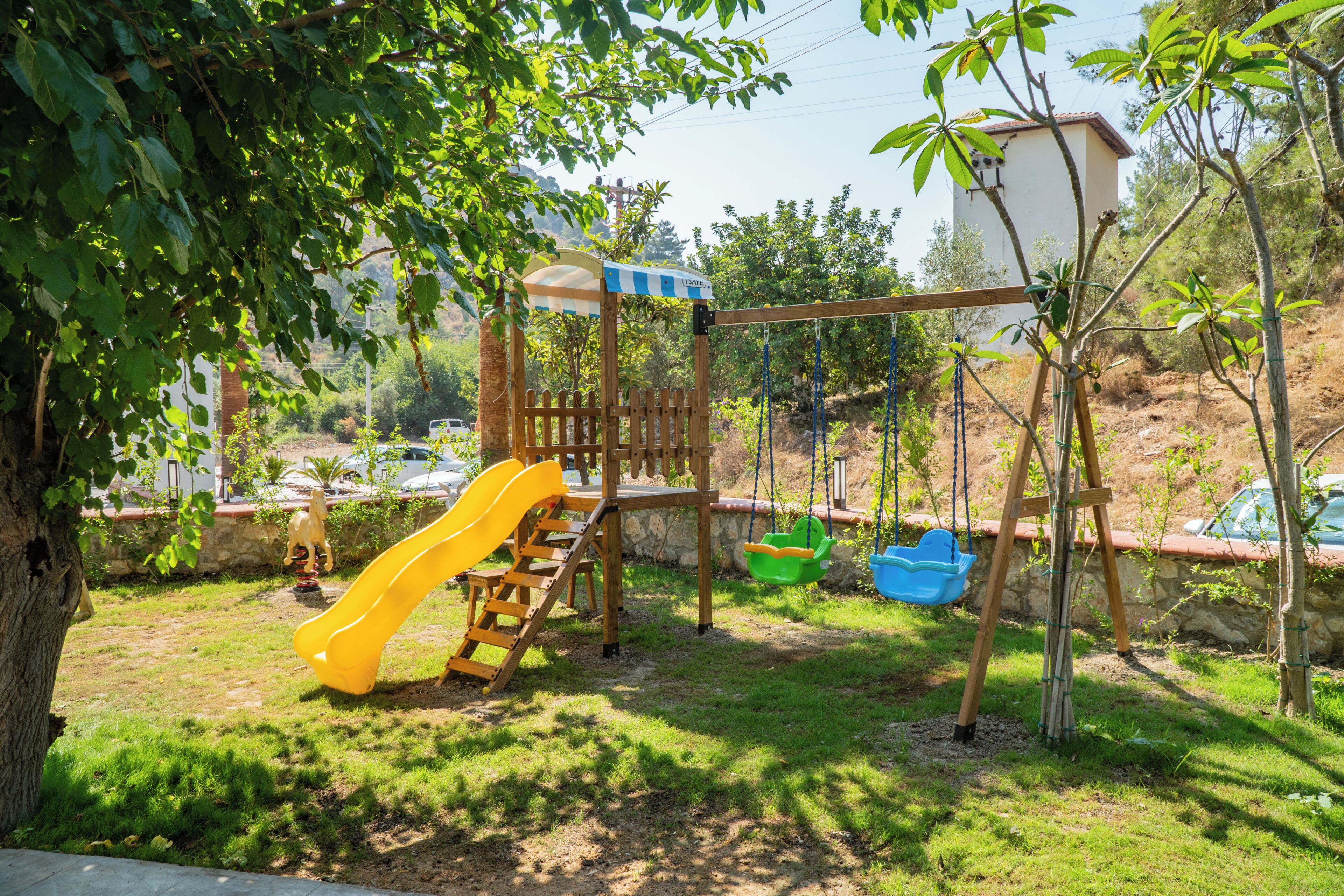 A playground with a slide, swings, and a climbing structure.