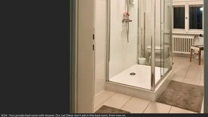 A private bathroom with a shower, a toilet, and a small table with a chair. - VILLA in VELDEN (Velden)
