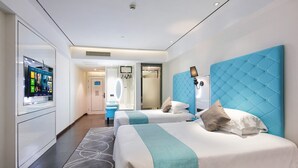 A hotel room with two beds, a TV, a mirror, and a bathroom visible through an open door. - Xi'an Hotel Xiaoshan Airport Branch (Hangzhou)