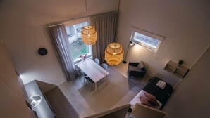 A compact hotel room with a dining area, a bed, and a view of the outdoors. - Spot Apartments Helsinki (Helsinki)