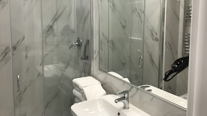 A modern bathroom with a glass-enclosed shower, a white sink, and a large mirror. - Affreschi Al Vaticano (Rome)