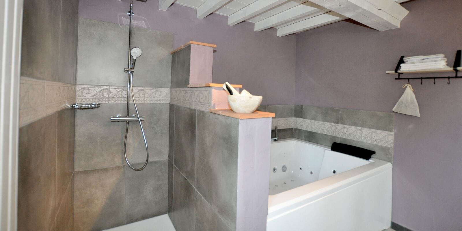A modern bathroom with a walk-in shower, a freestanding bathtub, and a vanity with a mirror.