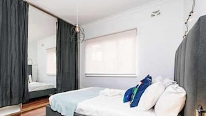 A modern bedroom with a bed, a window, and a mirror. - 3 Funky &Cool Family Coolbinia 2BR for 4 (Coolbinia)