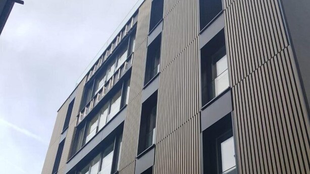 A multi-story building with a modern architectural design, featuring vertical lines and large windows. - Trendy New & Large 3 Beds, 90m2 in City Center (Luxembourg City)