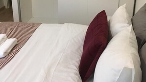 A hotel room with a bed, a wardrobe, and a hanging coat rack. - Trendy New & Large 3 Beds, 90m2 in City Center (Luxembourg City)