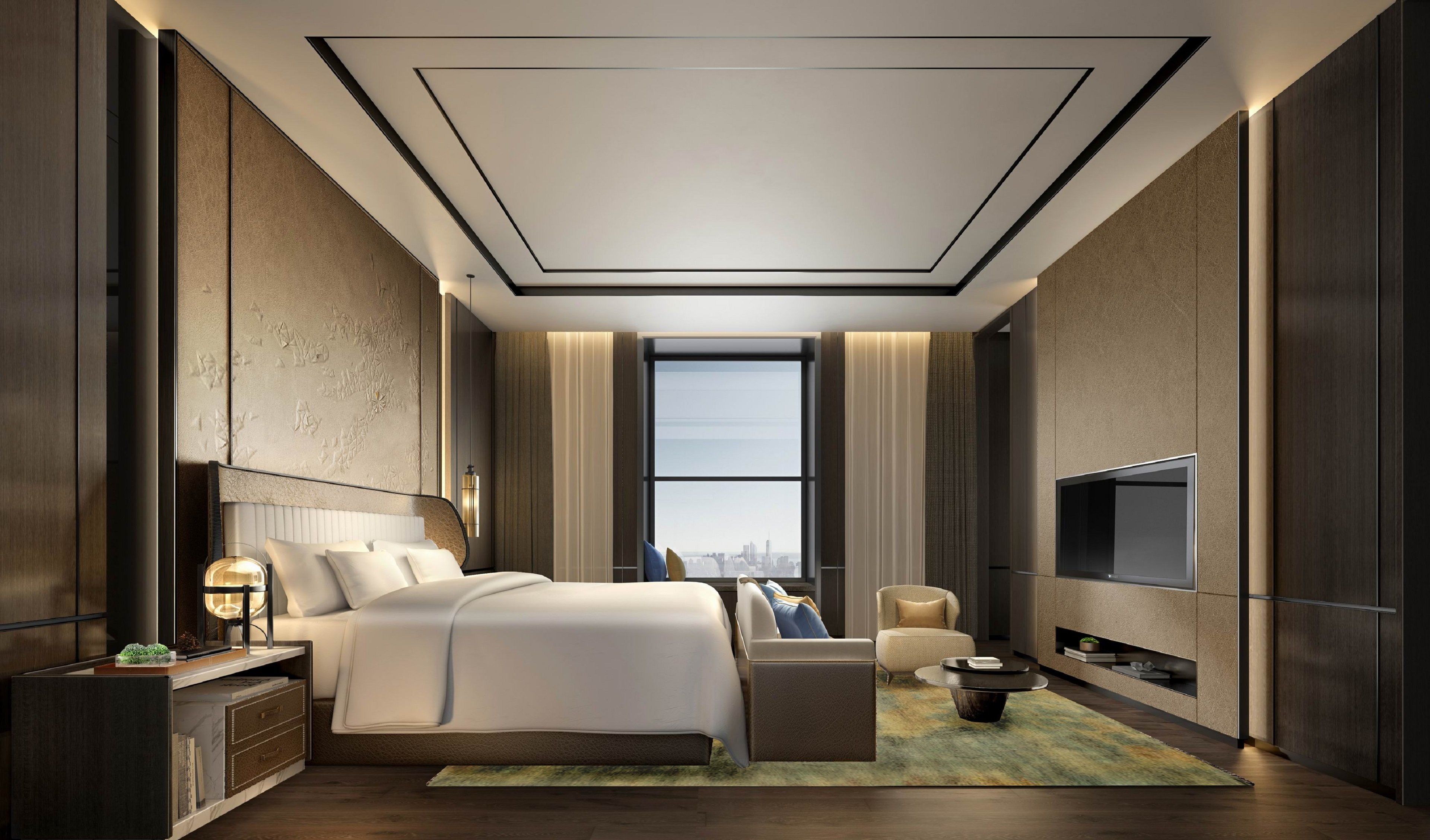 A modern hotel room with a large bed, a TV, a seating area, and a view of the city.