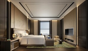 Habitación de hotel moderna con una cama grande, televisión, zona de estar y vistas a la ciudad.