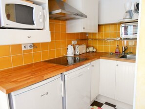 Kitchen area with microwave, dishwasher, sink, and cabinet.
