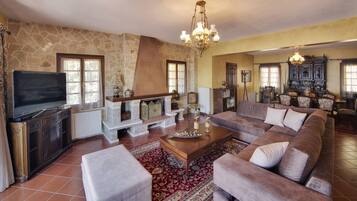 Deluxe Villa, 4 Bedrooms, Lake View | Living room | 33-inch LED TV with satellite channels, TV, fireplace