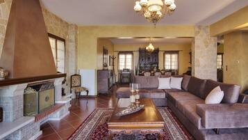 Deluxe Villa, 4 Bedrooms, Lake View | Living room | 33-inch LED TV with satellite channels, TV, fireplace